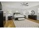 Bedroom with wood floors, ceiling fan, three windows and nice furnishings at 3320 Myrtle St, Edisto Island, SC 29438