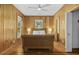 Bedroom boasts wood paneled walls, wood floors, and a wicker-style bed frame at 3320 Myrtle St, Edisto Island, SC 29438