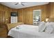 Bedroom boasts wood paneled walls, wood floors, and a wicker-style bed frame at 3320 Myrtle St, Edisto Island, SC 29438