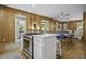 Open floor plan with kitchen island, dining area, and living room; wood plank walls at 3320 Myrtle St, Edisto Island, SC 29438