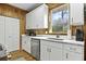 Bright kitchen features stainless steel appliances, white cabinets, and wood plank walls and floors at 3320 Myrtle St, Edisto Island, SC 29438