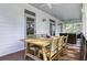 Inviting screened porch with wood dining table and comfortable wicker seating for outdoor gatherings at 3320 Myrtle St, Edisto Island, SC 29438