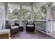 Relaxing screened porch with comfortable wicker chairs, a small table, and natural light at 3320 Myrtle St, Edisto Island, SC 29438