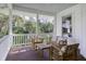 Relax on this cozy porch featuring a wooden bench, chairs, and table for outdoor enjoyment at 3320 Myrtle St, Edisto Island, SC 29438