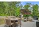 Back deck features patio dining set, lounge seating, outdoor grill, and lush green yard at 3360 Fickling Hill Rd, Johns Island, SC 29455