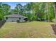 Back yard featuring a patio dining set, lounge seating, fire pit, and lush lawn at 3360 Fickling Hill Rd, Johns Island, SC 29455