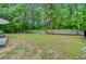 Grassy backyard with mature trees and privacy fence at 3360 Fickling Hill Rd, Johns Island, SC 29455