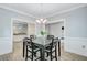 Dining room with modern chandelier, grey walls, and doorway to kitchen at 3360 Fickling Hill Rd, Johns Island, SC 29455