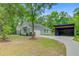 Home exterior showcasing attached garage, long driveway, and covered parking at 3360 Fickling Hill Rd, Johns Island, SC 29455