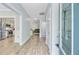 Well-lit foyer with hardwood floors, white walls, and views of the kitchen and living room at 3360 Fickling Hill Rd, Johns Island, SC 29455