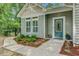 Inviting front entrance with a teal door, manicured landscaping, and walkway at 3360 Fickling Hill Rd, Johns Island, SC 29455
