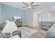 Comfortable living room with a large TV, ceiling fan, and natural light at 3360 Fickling Hill Rd, Johns Island, SC 29455
