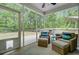 Enclosed porch with wicker furniture overlooking the backyard and deck at 3360 Fickling Hill Rd, Johns Island, SC 29455