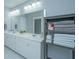 Bathroom featuring double vanity sinks, a large mirror, and linen storage at 3941 Bessemer Rd, Mount Pleasant, SC 29466