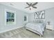 Cozy bedroom featuring two windows for natural light, neutral colors, and carpeted floors at 3941 Bessemer Rd, Mount Pleasant, SC 29466