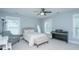Bright bedroom with a bed, accent chair, piano, and plenty of natural light from the windows at 3941 Bessemer Rd, Mount Pleasant, SC 29466
