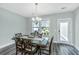 Formal dining room with a wooden table, chandelier, and view to the backyard at 3941 Bessemer Rd, Mount Pleasant, SC 29466