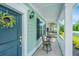 Inviting front porch with outdoor seating, complemented by a welcoming wreath on the front door at 3941 Bessemer Rd, Mount Pleasant, SC 29466