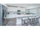 Stylish kitchen with white cabinets, stainless steel appliances, a large island with seating, and wood-look floors at 3941 Bessemer Rd, Mount Pleasant, SC 29466