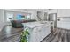 Kitchen island boasts white cabinets, stainless steel dishwasher, a sink, and quartz countertop at 3941 Bessemer Rd, Mount Pleasant, SC 29466