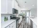 Modern kitchen with white countertops, stainless steel appliances and an eat-in dining area beyond at 3941 Bessemer Rd, Mount Pleasant, SC 29466