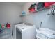 Well-equipped laundry room featuring modern washer and dryer, storage shelf, and ample space for organization at 3941 Bessemer Rd, Mount Pleasant, SC 29466