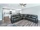 Open-concept living space featuring a sectional sofa and an eat-in kitchen with white cabinetry at 3941 Bessemer Rd, Mount Pleasant, SC 29466