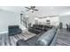 Open-concept living space featuring a sectional sofa and an eat-in kitchen with white cabinetry at 3941 Bessemer Rd, Mount Pleasant, SC 29466