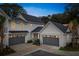 Inviting new construction home with elegant gray garage doors and tasteful landscaping at 401 Oak Hammock Ct # 48, Johns Island, SC 29455
