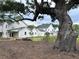 New construction homes featuring a farmhouse exterior style and beautiful live oak trees at 401 Oak Hammock Ct # 48, Johns Island, SC 29455