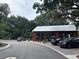 Inviting building exterior with patio seating under lush trees and black cars parked in front at 401 Oak Hammock Ct # 48, Johns Island, SC 29455