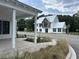 A modern home with a metal roof is beautifully complemented by lush greenery at 401 Oak Hammock Ct # 48, Johns Island, SC 29455