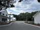 Street featuring modern homes, lush trees, and green spaces at 401 Oak Hammock Ct # 48, Johns Island, SC 29455