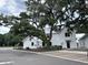 Street view of new white construction homes with landscaping and brick parking at 401 Oak Hammock Ct # 48, Johns Island, SC 29455