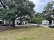 Beautiful street view of green lawn with landscaping and trees, interspersed with buildings at 401 Oak Hammock Ct # 48, Johns Island, SC 29455