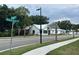 Charming street view showcasing the architecture and lush landscaping, enhanced by palm trees and street signage at 401 Oak Hammock Ct # 48, Johns Island, SC 29455