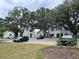 Street level view of community building lined with landscaping and parking for residents and visitors at 401 Oak Hammock Ct # 48, Johns Island, SC 29455
