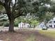 Street level of building exteriors with green lawn landscaping and trees and parking at 401 Oak Hammock Ct # 48, Johns Island, SC 29455