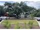 Well maintained lawn with green landscaping with large oak trees, with white and red building facades at 401 Oak Hammock Ct # 48, Johns Island, SC 29455
