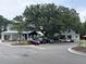 Street view of parking area featuring multiple cars and beautiful landscaping and trees at 401 Oak Hammock Ct # 48, Johns Island, SC 29455