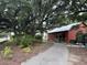 Picturesque walking path with mature trees, lush landscaping, and a view of a charming building along the path at 401 Oak Hammock Ct # 48, Johns Island, SC 29455