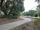 Picturesque walking path surrounded by lush trees and landscaping offers a serene and inviting outdoor experience at 401 Oak Hammock Ct # 48, Johns Island, SC 29455