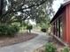 Tranquil view of a winding walking path framed by lush greenery and mature trees with a building visible to the right at 401 Oak Hammock Ct # 48, Johns Island, SC 29455