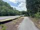 Scenic walking path lined with lush greenery, perfect for enjoying the neighborhood's natural beauty and promoting an active lifestyle at 401 Oak Hammock Ct # 48, Johns Island, SC 29455