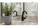 Bathroom featuring granite countertop, potted plant and matte black water fixtures for a sleek and modern design at 42 Poinsett St, Charleston, SC 29403