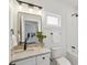 Beautiful bathroom with granite countertops, matte black fixtures, and a shower/tub combo at 42 Poinsett St, Charleston, SC 29403