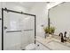 Modern bathroom featuring a glass-enclosed shower, granite countertop, and matte black fixtures for a sleek design at 42 Poinsett St, Charleston, SC 29403