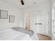 Bright bedroom featuring wood floors, white walls, white trim and a ceiling fan at 42 Poinsett St, Charleston, SC 29403
