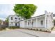 Beautiful home with white siding, a covered porch, an open layout, and fresh landscaping, offering outdoor charm at 42 Poinsett St, Charleston, SC 29403