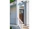 Close-up of the front door with white railing, showcasing the detail of the entryway, creating inviting welcome at 42 Poinsett St, Charleston, SC 29403